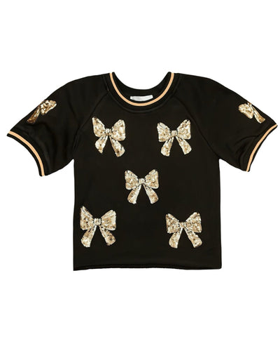 Black top with gold bow embellishments on a white background For girls ages 7-14