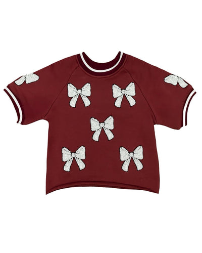 Maroon sweater with white bow designs for girls ages 7-14. Perfect for game day outfits